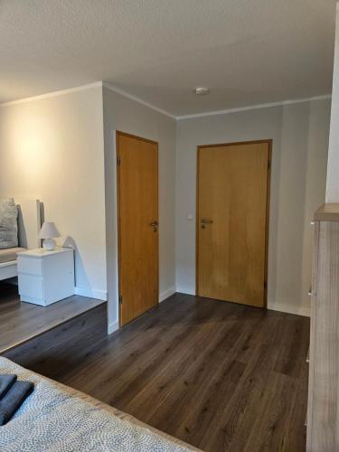 an empty room with two doors and a bed at Bördeapartment 1 in Vahldorf