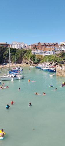 a group of people swimming in a body of water at Sunset retreat caravan with large wrap around decking in Newquay