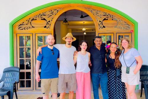 a group of people standing in front of a door at Gamagedara Resort in Dambulla