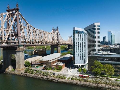 a bridge over a river with a city at Graduate by Hilton New York in New York