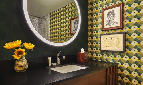 a bathroom with a sink and a mirror at Graduate by Hilton Eugene in Eugene