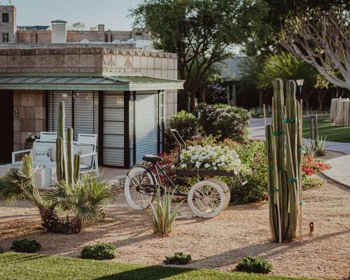 a bike parked in a garden with flowers and cactus at Arizona Biltmore, LXR Hotels & Resorts in Phoenix