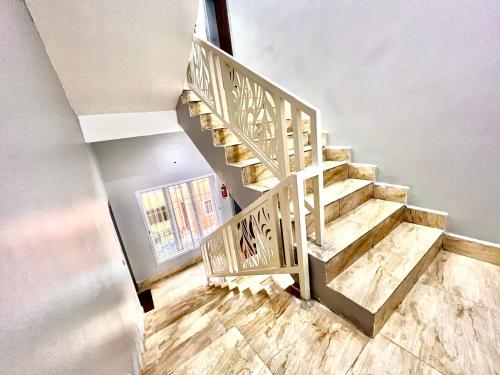 a wooden staircase in a room with wooden floors at FURNISHED APARTMENTS UTAKO ABUJA Between Wuse & Jabi District PLS VIEW Flat PHOTOS B4 BOOKING in Abuja