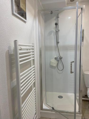 a shower with a glass door in a bathroom at Parvis de la cathédrale de Bayeux vue directe in Bayeux