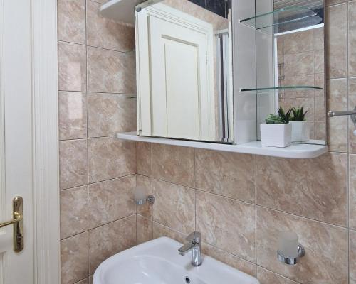 a bathroom with a sink and a mirror at Luxury Apartments Montesan in Sveti Stefan