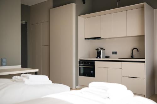 a kitchen with white cabinets and white appliances at Taunus Suites in Oberursel