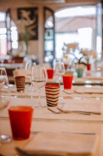 a table with wine glasses and plates on it at Ca’ Bruno Masaneta in Grado