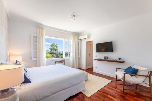 a white bedroom with a large bed and a window at Aurora Boutique Hotel - Only Adults in Marbella