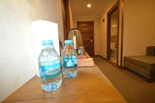 two bottles of water sitting on a table in a hotel room at Arsisa in Avcılar