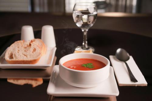 a bowl of soup and a glass of wine and bread at Arsisa in Avcılar