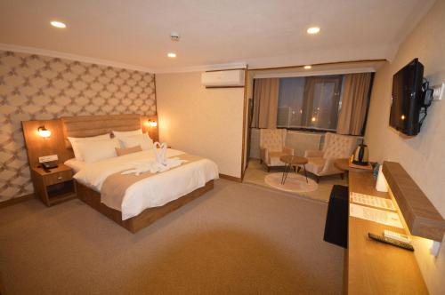 a hotel room with a large bed and a television at Arsisa in Avcılar