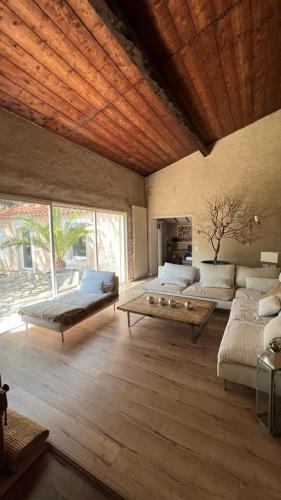 un salon avec deux lits et une table dans l'établissement Ales maison de ville tout confort piscine jardin parking 6 personnes, à Alès