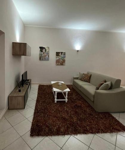 a living room with a couch and a table at Duomo Girgenti Loft in Agrigento