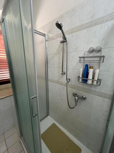 a shower with a glass door in a bathroom at Duomo Girgenti Loft in Agrigento