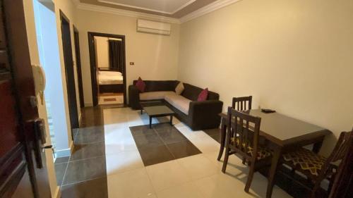 a living room with a couch and a table at Paradise residence in Dumyāţ al Jadīdah