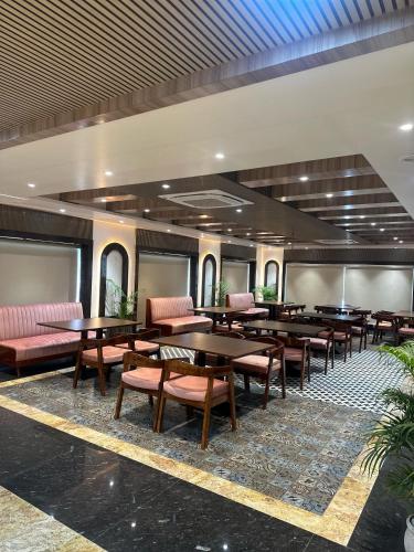瓦拉纳西Hotel Sainik Grand的有桌椅的餐厅