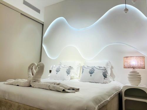 a bedroom with a bed with a swan on it at Luxury 1BR Apt Best view Infinity Pool Burj Khalifa with Balcony in Dubai