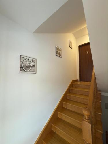 a hallway with stairs and a wooden door at Apartament Jaśminowa in Chrzanów