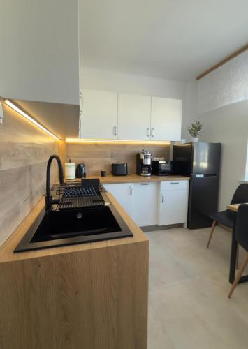 a kitchen with a counter with a sink in it at Apartament Jaśminowa in Chrzanów