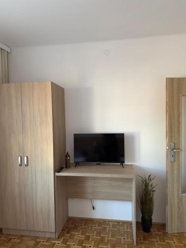 a room with a desk with a flat screen tv at Apartament Jaśminowa in Chrzanów