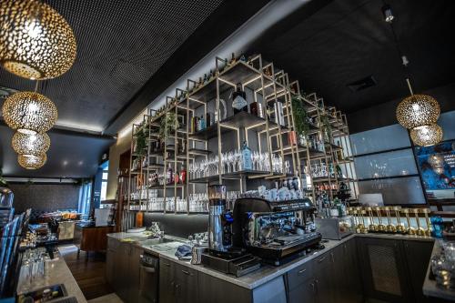 a bar with a shelf with glasses on it at Hotel Stadt Wien in Bad Schallerbach