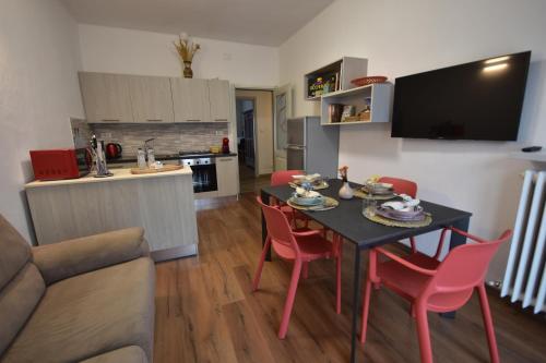 a kitchen and living room with a table and chairs at Ca' Elide in Aosta