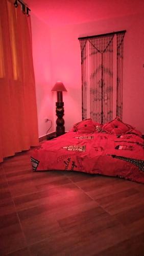 a red bedroom with a bed with a red light at DESTINY Apto villas del Río in San Rafael