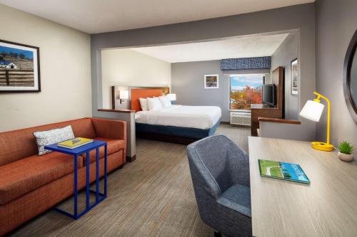 a hotel room with a bed and a couch at Hampton Inn Lexington South-Keeneland Airport in Lexington