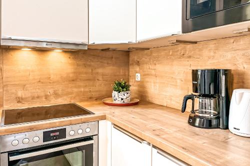 a kitchen with a counter top with a coffee maker at Strandblick - Dorf 1 Ferienhaus 01 in Priwall