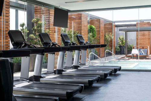 a row of treadmills in a gym with a swimming pool at Hilton Mexico City Santa Fe in Mexico City