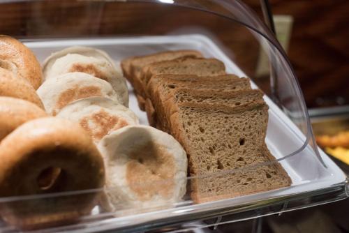 a plastic tray filled with different types of bread and donuts at Hampton Inn and Suites Woodstock, Virginia in Woodstock