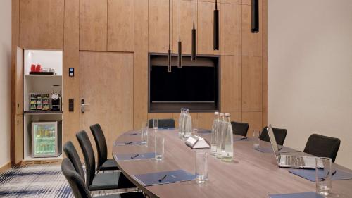 a conference room with a long table and chairs at Hilton Munich Airport in Oberding