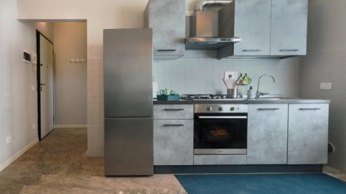 a kitchen with stainless steel appliances and a stove at Gabry family apartment in Prato