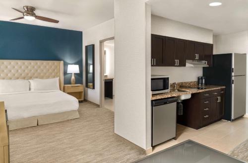a hotel room with a bed and a kitchen at Homewood Suites by Hilton Palo Alto in Palo Alto