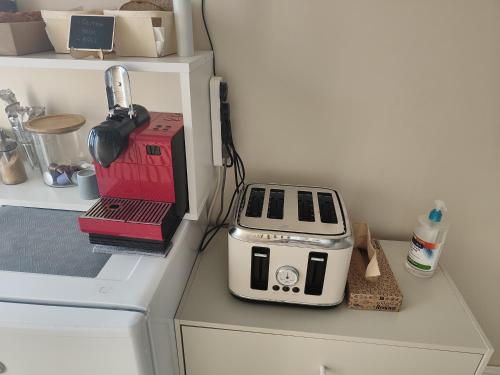 a toaster sitting on top of a counter in a kitchen at Clifton House O2 & Excel Rooms with private bathroom and Breakfast option in London