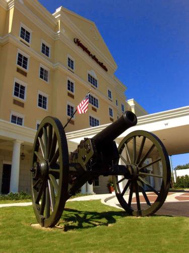 a cannon sitting in the grass in front of a building at Hampton Inn & Suites - Vicksburg in Vicksburg
