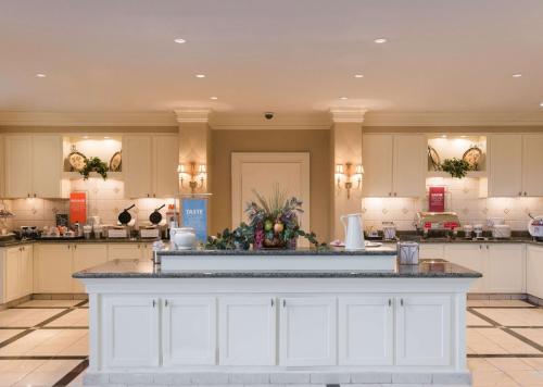 a large kitchen with white cabinets and a large island at Hampton Inn & Suites - Vicksburg in Vicksburg