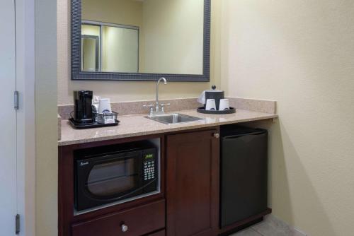 a bathroom with a sink and a microwave at Hampton Inn & Suites - Vicksburg in Vicksburg