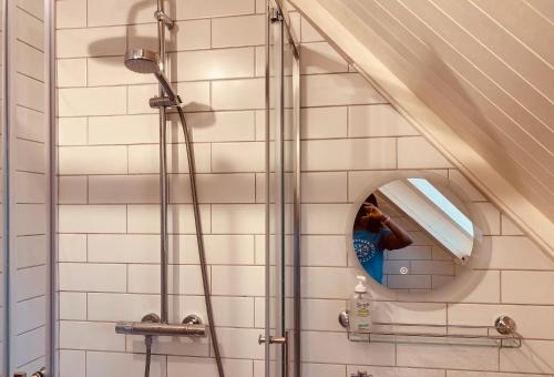 a bathroom with a shower and a mirror at The Hill, Great Walsingham in Little Walsingham