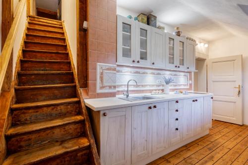 a kitchen with a sink and a staircase with a sink at U Leknínu in Doksy