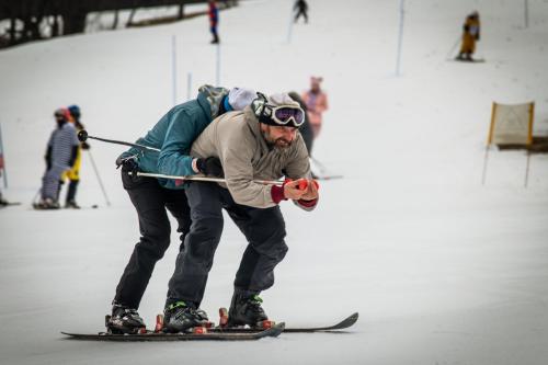 two men on skis on a ski slope at Penzion U školy in Staré Město