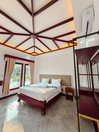 a bedroom with a bed and a large ceiling at Nakasang Paradise Hotel in Nakasong