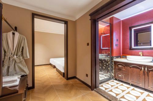a bathroom with a sink and a mirror at Beijing Xiaofengxian Former Residence Hotel Tiananmen Square Qianmen Store in Beijing