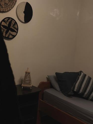 a bedroom with a bed and hats on the wall at Chic Surf House in Aourir