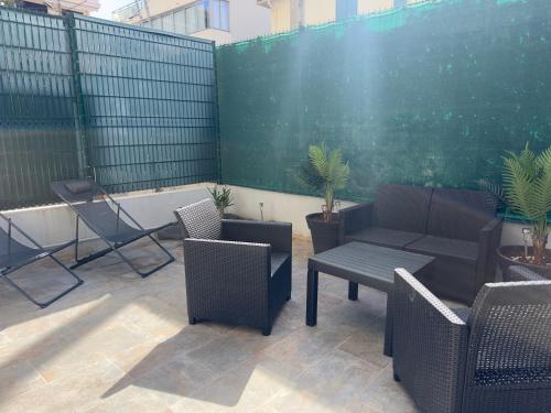 un patio avec des chaises et une table et une clôture dans l'établissement COSY CASTILLE - Proche de la CROISETTE, à Cannes
