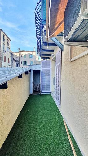 - un balcon avec de l'herbe verte sur le côté du bâtiment dans l'établissement Cannes 1-Bedroom Apartment - 15M, à Cannes