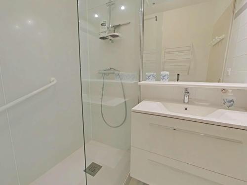 une salle de bain blanche avec une douche et un lavabo dans l'établissement Charmant 2 pièces, 4 couchages, balcon, parking, à 2 pas de la Grande Plage de Saint-Gilles-Croix-de-Vie - FR-1-224-813, à Saint-Gilles-Croix-de-Vie