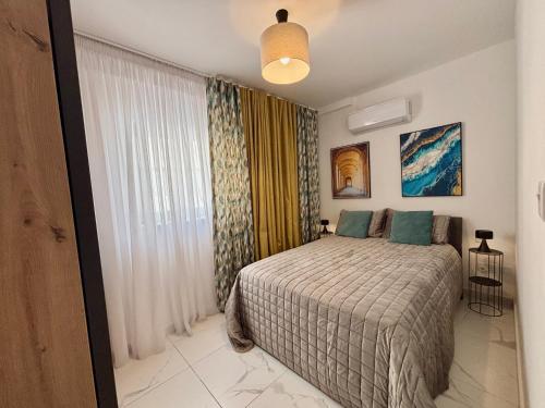 a bedroom with a bed and a window at Steps to Sea - Affordable Luxury Living in St. Paul's Bay