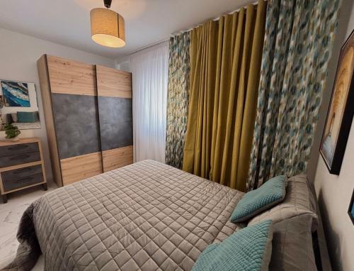 a bedroom with a bed and a curtain at Steps to Sea - Affordable Luxury Living in St. Paul's Bay