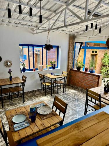a dining room with wooden tables and chairs at Maison Ubururu in Kigali